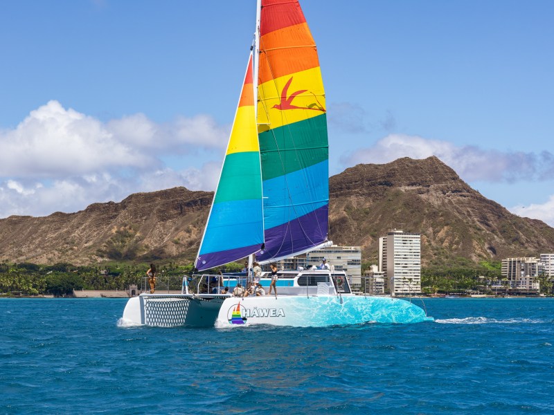 a blue and white boat sitting next to a body of water