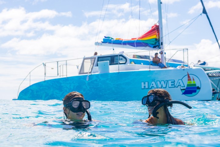 a group of people riding on the back of a boat