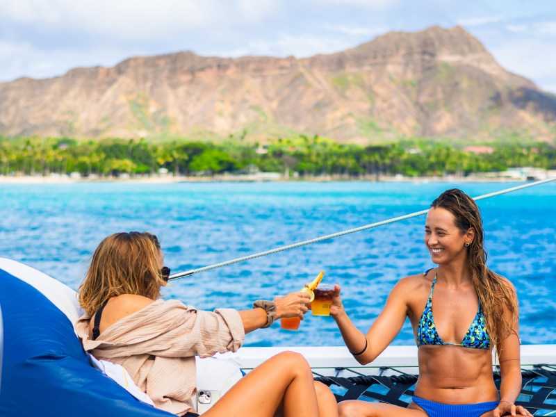 a man and woman sitting next to a body of water