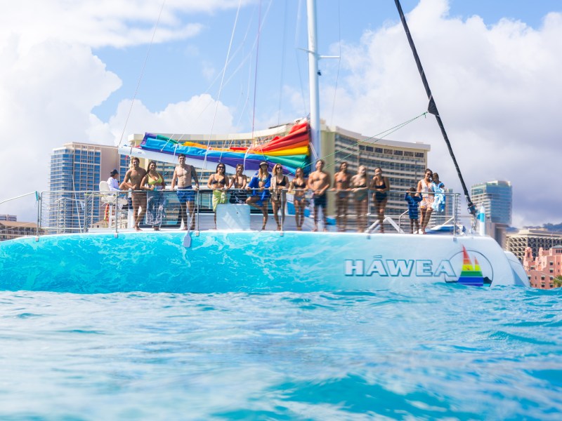 a blue and white boat sitting next to a body of water